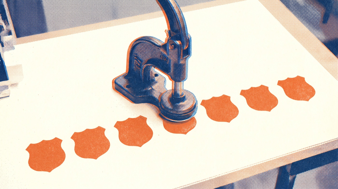 Risograph-style print in orange and blue of a cast-iron hand press on a bright workbench, stamping the latest in a row of seven identical shield-shaped badges.